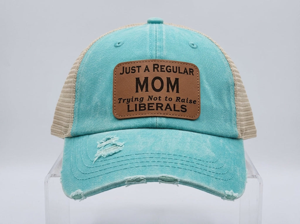 Just A Regular Mom Trying Not to Raise Liberals Distressed Teal Trucker Hat