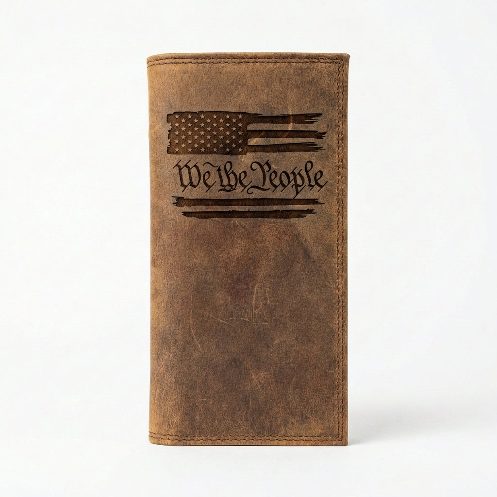 Distressed brown leather long wallet featuring an engraved American flag and calligraphic We The People text.