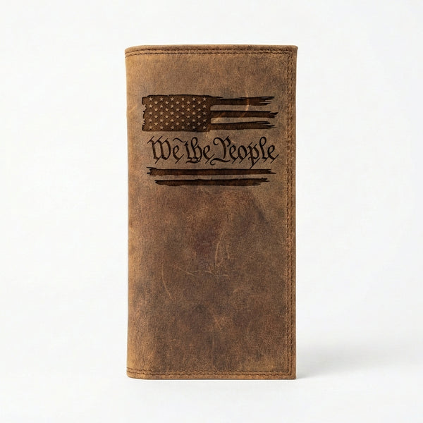 Distressed brown leather long wallet featuring an engraved American flag and calligraphic We The People text.