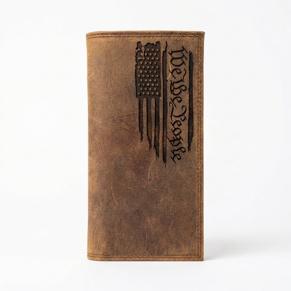 Brown leather long wallet with an engraved distressed American flag and "We the People" script.
